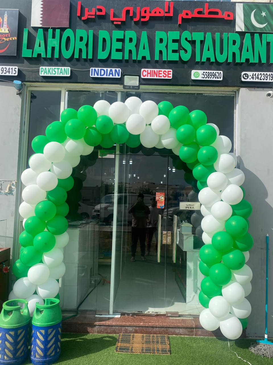 white and green colour balloon arch